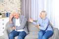 Mature couple arguing in living room. Royalty Free Stock Photo