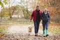 Mature Couple On Autumn Walk With Labrador Royalty Free Stock Photo