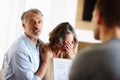 Mature couple, bad news or stress in home with surprise, crying or sad in meeting with financial advisor. Senior, man Royalty Free Stock Photo