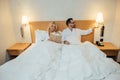 mature couple in bathrobes lying in bed and woman Royalty Free Stock Photo