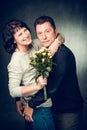 Mature couple with a bouquet of flowers. Mature couple. Royalty Free Stock Photo