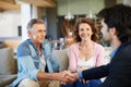 Mature couple, broker and handshake in house for mortgage for retirement in planning, finances and advice. Man, woman Royalty Free Stock Photo