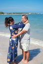 Mature couple calm and relax hugging each other standing at the beach during summer Royalty Free Stock Photo