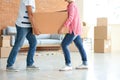 Mature couple carrying box indoors. Moving into new house Royalty Free Stock Photo