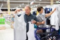 Mature couple choosing tank tops in clothes department in grocery store Royalty Free Stock Photo