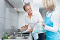 Mature couple cleaning utensils Royalty Free Stock Photo