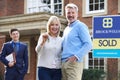 Mature Couple Collecting Keys To New Home From Realtor Royalty Free Stock Photo