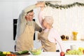 Mature Couple Dancing In Kitchen, Having Fun Cooking On Christmas Royalty Free Stock Photo