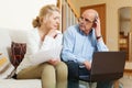 Mature couple with documents and laptop Royalty Free Stock Photo
