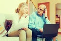 Mature couple with documents and laptop Royalty Free Stock Photo