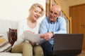 Mature couple with documents and notebook Royalty Free Stock Photo