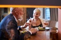 Mature couple fine dining food in hotel or elegant expensive restaurant