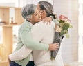 Mature couple, flowers and hug at home for anniversary, birthday or valentines celebration. Surprise, love and roses or Royalty Free Stock Photo