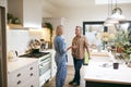 Mature Couple Having Discussion In Kitchen At Home Together Royalty Free Stock Photo