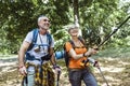 Mature couple hiking in forest wearing backpacks and hiking poles. Nordic walking, trekking. Healthy lifestyle Royalty Free Stock Photo