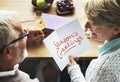 Mature couple holding a Season`s Greeting card Royalty Free Stock Photo