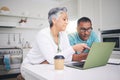 Mature couple, laptop and pointing for internet connection, communication or social media post. A man and woman talking Royalty Free Stock Photo