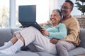 Mature couple, laptop and relax on sofa in living room, house and home on streaming subscription, online shopping and Royalty Free Stock Photo