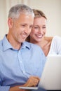 Mature couple, laptop and smiling with video call, conversation and living room couch. Social media, technology and Royalty Free Stock Photo