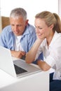 Mature couple, laptop and video call with conversation, smile and kitchen counter. Social media, technology and Royalty Free Stock Photo