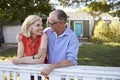 Mature Couple Leaning On Back Yard Fence Royalty Free Stock Photo