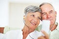 Mature couple listening music together. Closeup of happy mature couple listening music together at home. Royalty Free Stock Photo