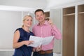 Mature Couple Looking At Plans For New Luxury Kitchen Royalty Free Stock Photo