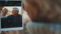 Mature couple in love taking selfie in forest on autumn day. Video call or browsing old photos Royalty Free Stock Photo