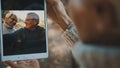 Mature couple in love taking selfie in forest on autumn day. Video call or browsing old photos Royalty Free Stock Photo