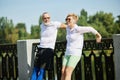 Mature couple, man and woman training outdoors, doing stretching and warming-up exercises on warm summer morning Royalty Free Stock Photo