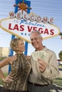 Mature Couple With Money And Welcome Sign In The Background Royalty Free Stock Photo