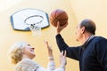 Mature couple playing basketball in patio Royalty Free Stock Photo