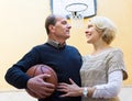 Mature couple playing basketball in patio Royalty Free Stock Photo