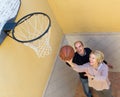 Mature couple playing basketball in patio Royalty Free Stock Photo