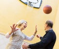 Mature couple playing basketball in patio Royalty Free Stock Photo