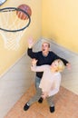 Mature couple playing basketball in patio Royalty Free Stock Photo