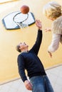 Mature couple playing basketball in patio Royalty Free Stock Photo