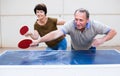 Mature couple playing ping pong Royalty Free Stock Photo