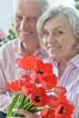 Mature couple with poppies Royalty Free Stock Photo