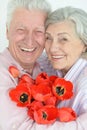 Mature couple with poppies Royalty Free Stock Photo