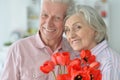 Mature couple with poppies Royalty Free Stock Photo