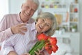 Mature couple with poppies Royalty Free Stock Photo