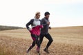 Mature Couple Running Around Autumn Field Together Royalty Free Stock Photo