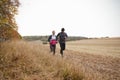 Mature Couple Running Around Autumn Field Together Royalty Free Stock Photo