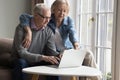 Mature couple making order through e-services use laptop