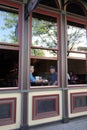 Mature couple seen through restaurant window.