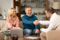 Mature Couple Shaking Hands With Professional Real Estate Agent Indoors Royalty Free Stock Photo