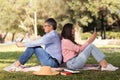 Mature Couple Sitting Back To Back And Using Smartphones In Park Outdoors Royalty Free Stock Photo