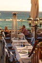 Mature couple sitting on restaurant on sea coast