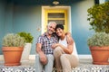 Mature Couple Sitting On Steps Outside House Royalty Free Stock Photo